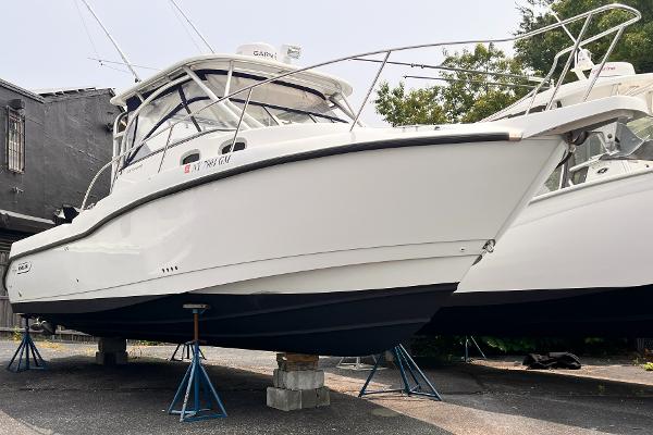 Boston Whaler 305 Conquest 2005 Boston Whaler 305 Conquest boat on stands, side view, outdoors.