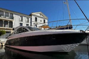 Beneteau Gran Turismo 44 2012 Beneteau Gran Turismo 44 yacht docked near elegant waterfront buildings.