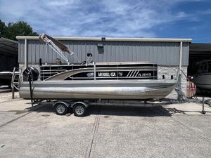 Bennington 22 LS 2022 Bennington 22 LS pontoon boat on trailer, parked outside a metal building.