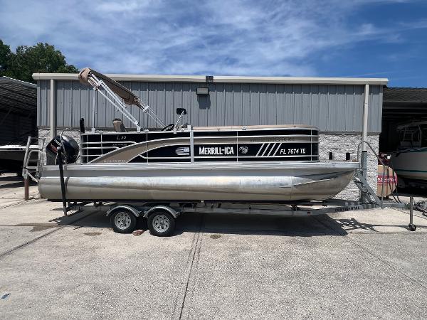Bennington 22 LS 2022 Bennington 22 LS pontoon boat on trailer, parked outside a metal building.