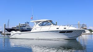 Pursuit OS 355 Offshore 2023 Pursuit OS 355 Offshore boat docked in a marina under clear blue skies.