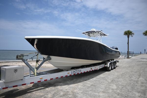 Yellowfin 36 2004 Yellowfin 36 boat on trailer by the shore.