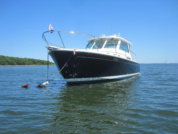 Back Cove 34 HARD TOP/HARD BACK 2014 Back Cove 34 Hard Top boat anchored on calm water.