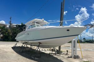Donzi 38 ZF Cuddy 2007 Donzi 38 ZF Cuddy boat on stands under a clear blue sky.