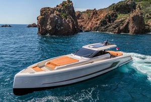 Wider Wilder 60 2024 Wider Wilder 60 yacht cruising near rocky coastline in clear blue waters.
