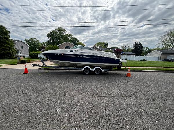 Sea Ray 240 Sundeck 2007 Sea Ray 240 Sundeck boat on trailer, parked on suburban street.