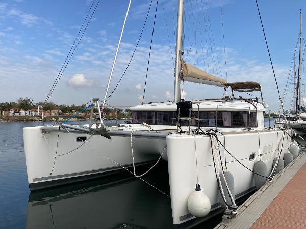 Lagoon 400 S2 2016 Lagoon 400 S2 catamaran docked in a marina under a clear blue sky.