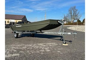 Polar Kraft 1648 Jon Boat, 15" transom with Trailer 2024 Polar Kraft 1648 Jon Boat on trailer, parked outdoors under clear blue sky.