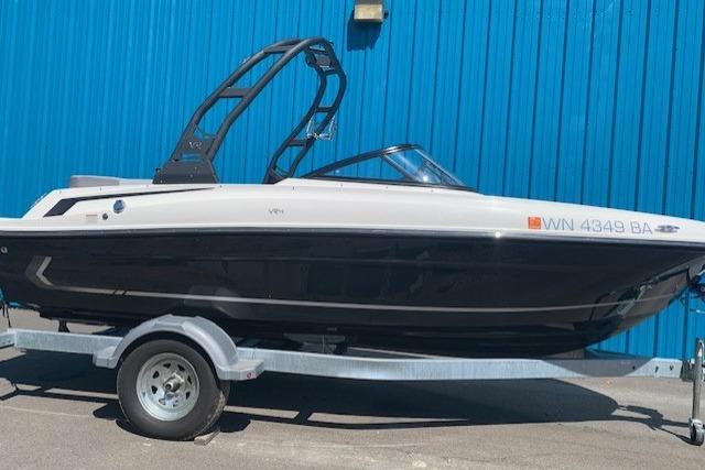 Bayliner VR4 Bowrider I/O 2022 Bayliner VR4 Bowrider I/O boat on trailer, parked by blue wall.