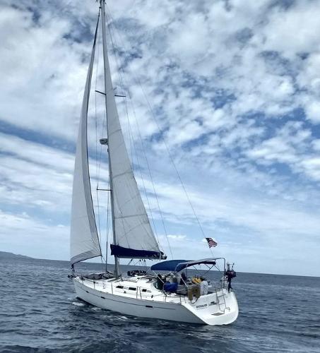 Beneteau Oceanis Clipper 393 2002 Beneteau Oceanis Clipper 393 sailing on open water under a cloudy sky.
