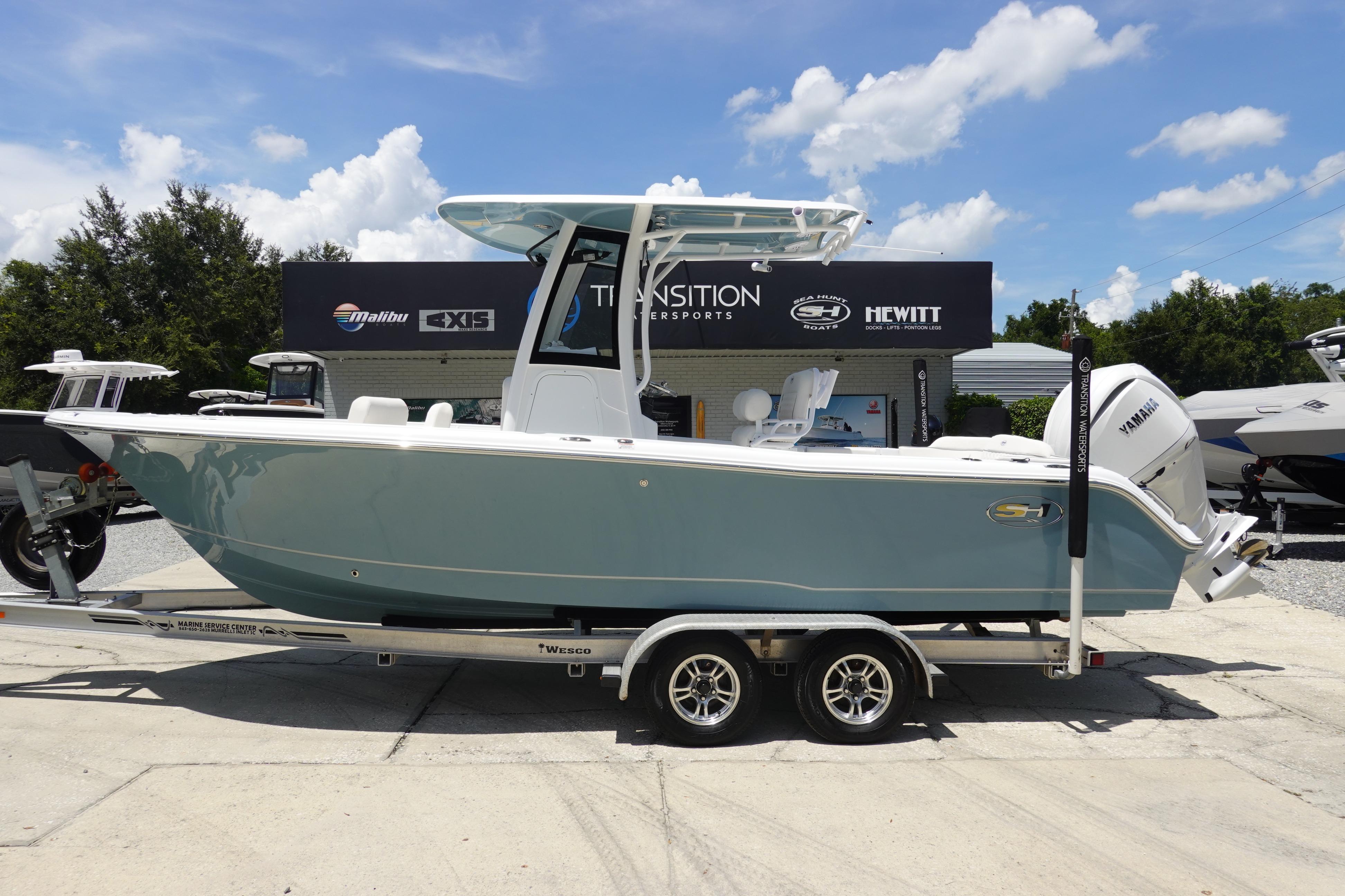 Sea Hunt Ultra 235 SE 2026 Sea Hunt Ultra 235 SE boat on trailer, displayed outdoors under a clear sky.