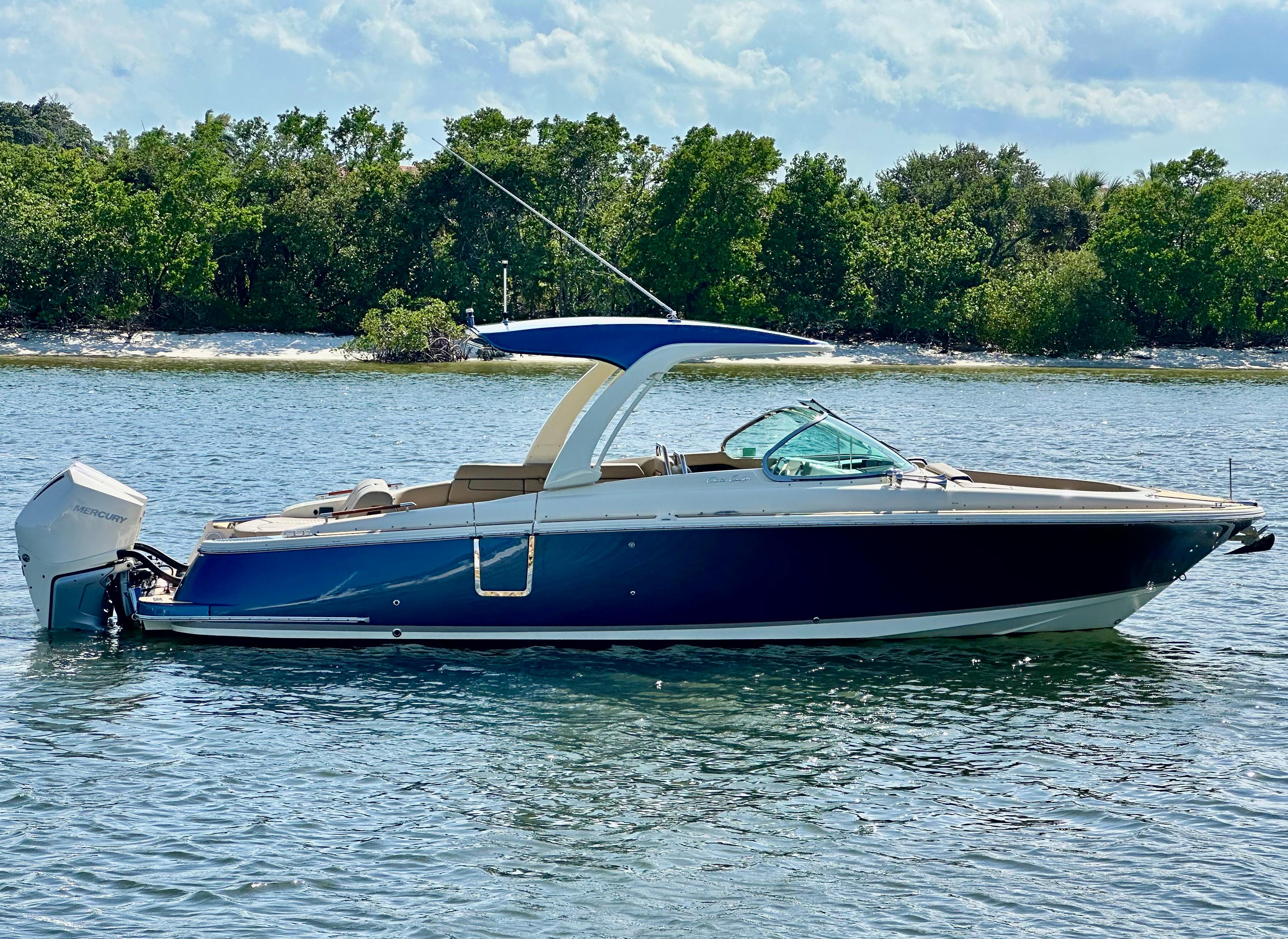 Chris-Craft Launch 31 GT 2023 Chris-Craft Launch 31 GT boat on water, surrounded by lush greenery.