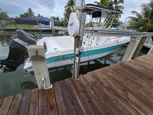 Pro Sports 25 2006 Pro Sports 25 boat docked, featuring Suzuki outboard motor, surrounded by tropical scenery.