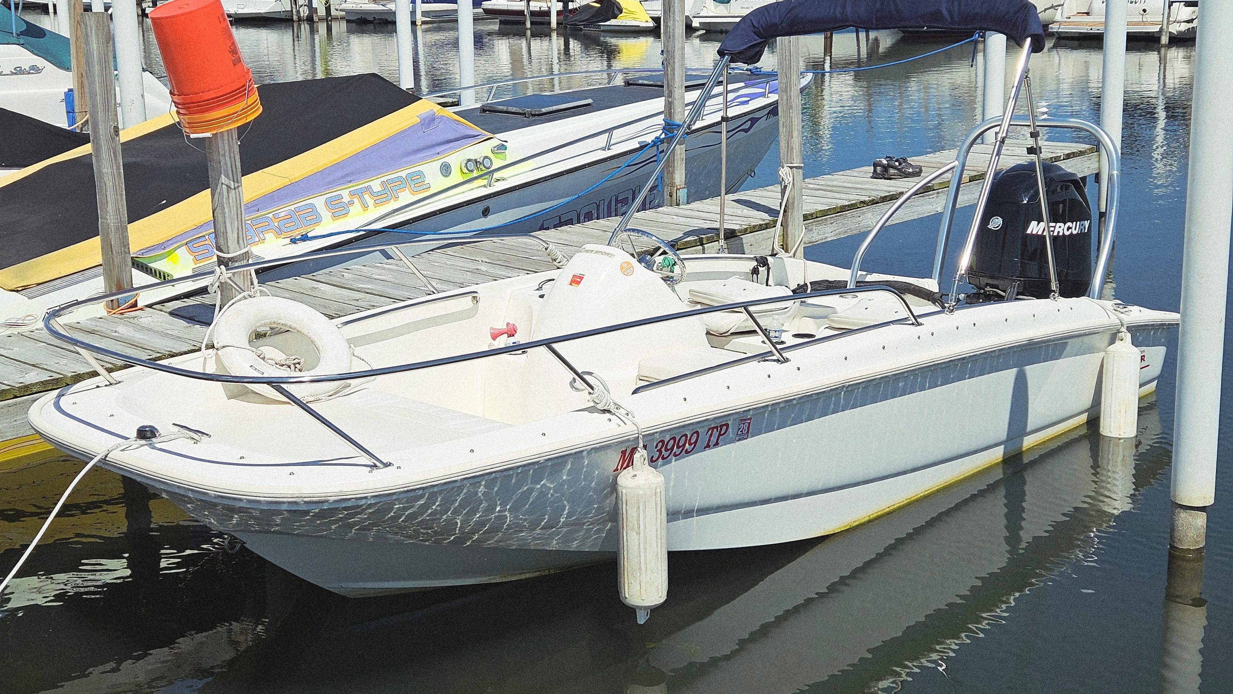 Boston Whaler 17 Super Sport 2012 Boston Whaler 17 Super Sport docked, featuring a Mercury outboard motor.
