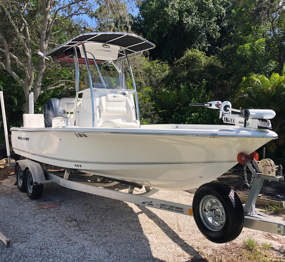 Sea Hunt BX 22 BR 2016 Sea Hunt BX 22 BR boat on trailer, surrounded by lush greenery.