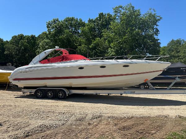 Formula 400 Super Sport 2001 Formula 400 Super Sport boat on trailer, parked outdoors with trees in background.