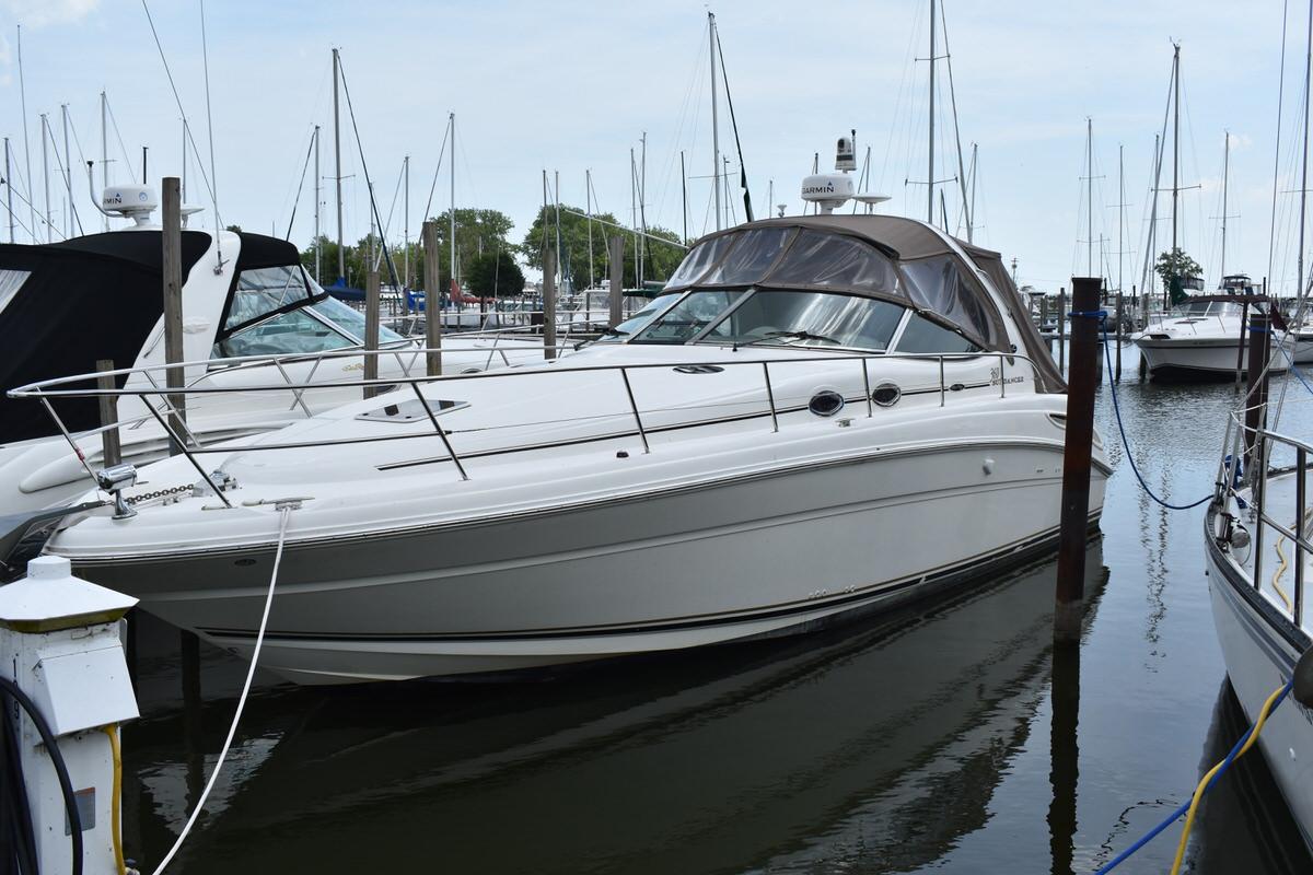 Sea Ray 360 Sundancer 2003 Sea Ray 360 Sundancer yacht docked in a marina, surrounded by sailboats.