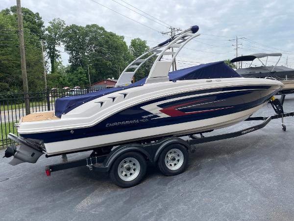 Chaparral 23 SSi 2024 Chaparral 23 SSi boat on trailer, sleek design, parked outdoors.