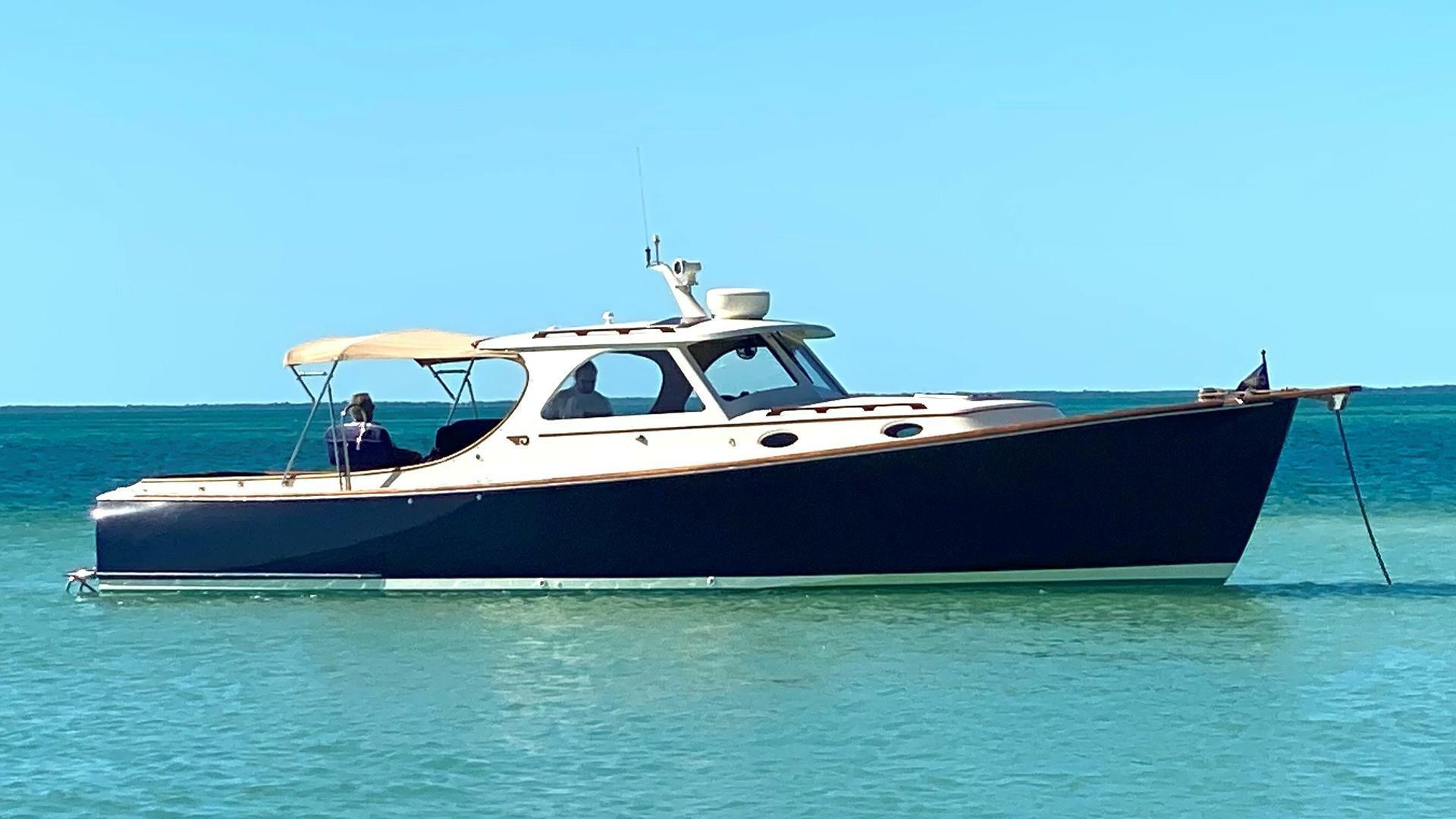Hinckley 36 Classic 1998 Hinckley 36 Classic yacht anchored in clear blue water.