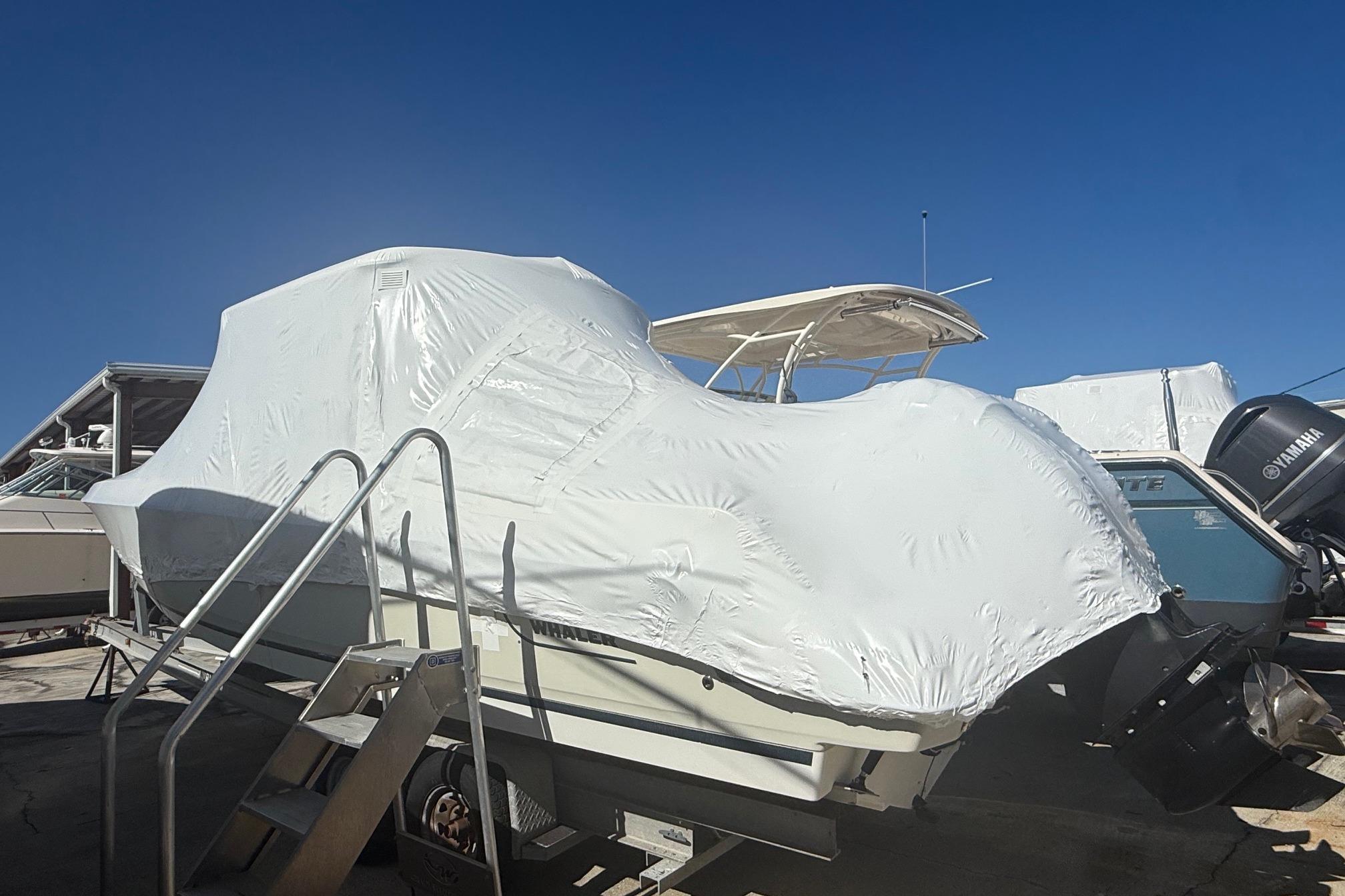 Boston Whaler 270 Vantage 2018 Boston Whaler 270 Vantage boat covered in protective wrap, parked outdoors.