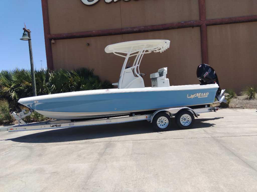 Mako 24 APEX 2025 Mako 24 APEX boat on trailer, blue hull, parked outdoors.