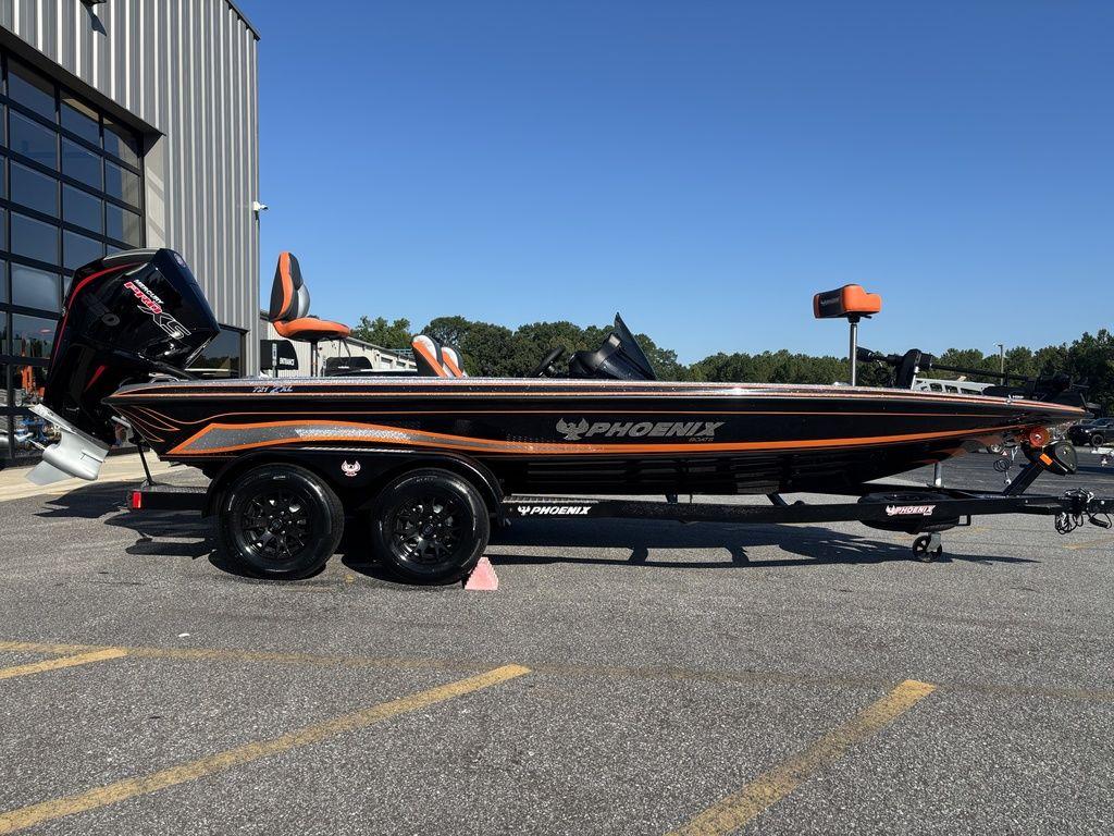 Phoenix 721 ZXL 2026 Phoenix 721 ZXL bass boat on trailer, parked outdoors, side view.