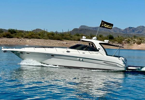 Sea Ray 460 Sundancer 2003 Sea Ray 460 Sundancer cruising on a lake with mountainous backdrop.