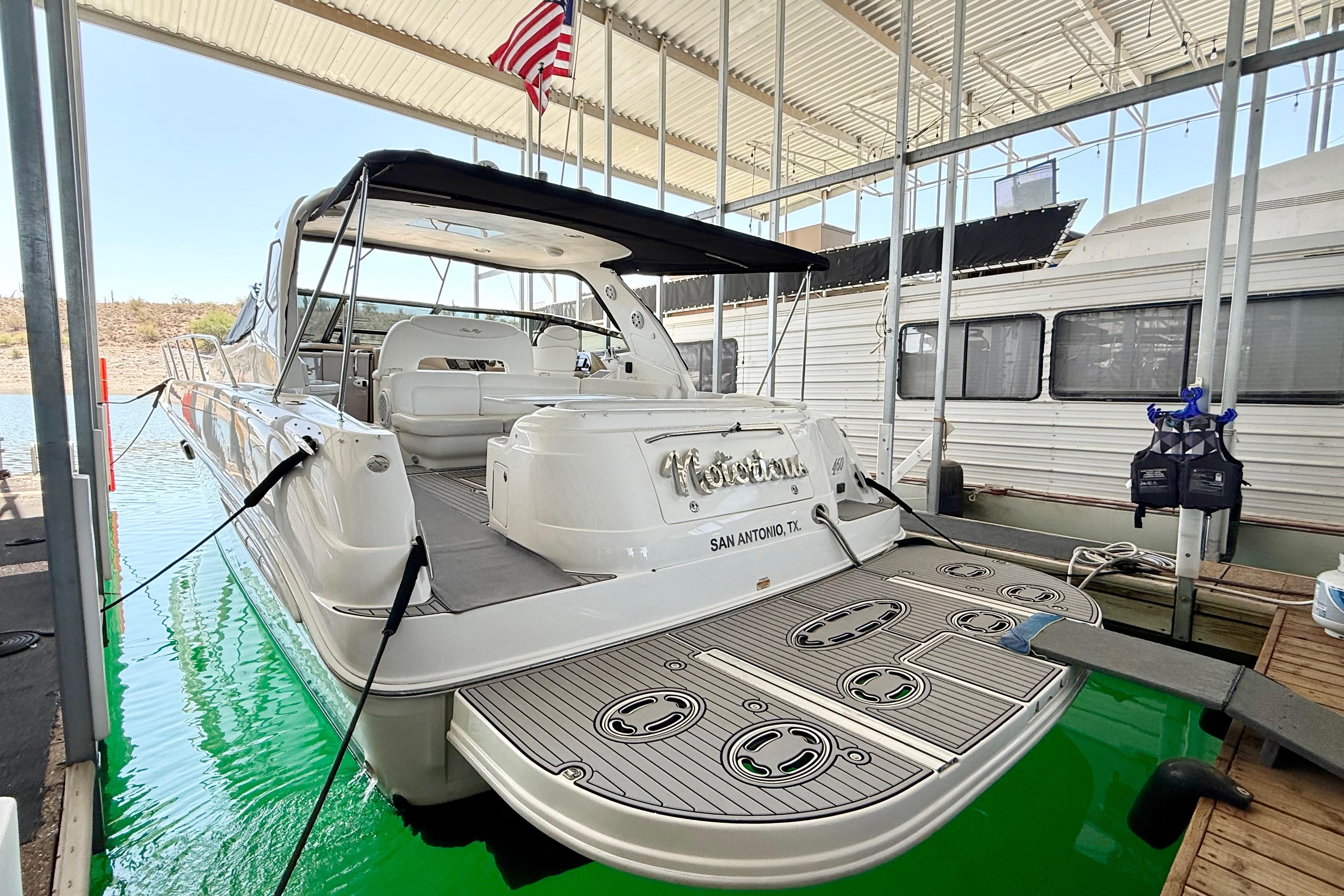 Sea Ray 460 Sundancer 2003 Sea Ray 460 Sundancer yacht docked in a marina, rear view with American flag.