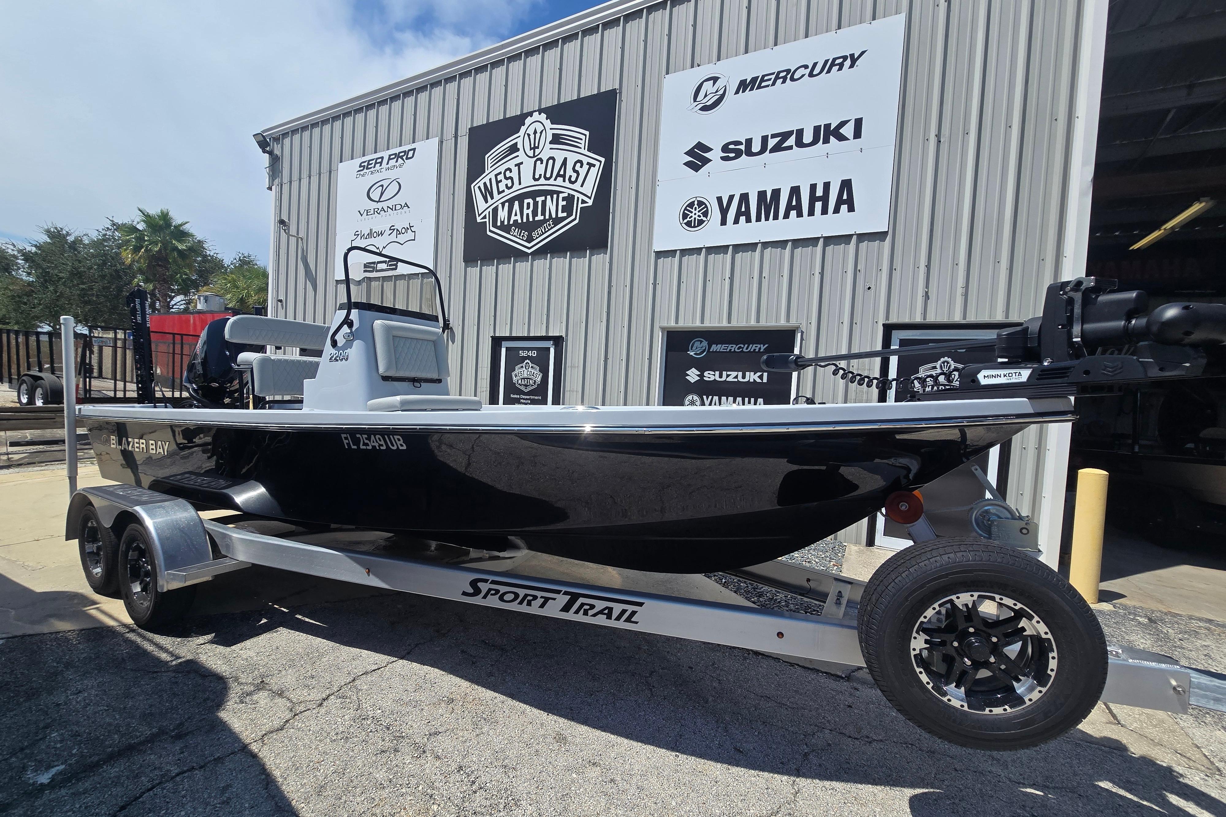 Blazer 2200 2025 Blazer Bay 2200 boat on trailer at West Coast Marine dealership.