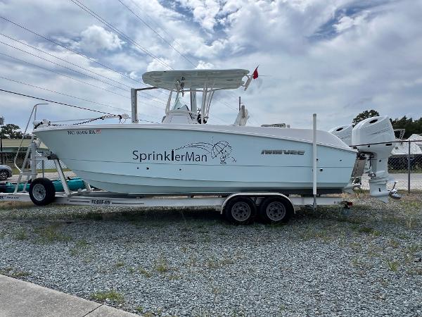 Twin Vee 240 GFX CC 2022 Twin Vee 240 GFX CC boat on trailer, labeled "SprinklerMan," under cloudy sky.