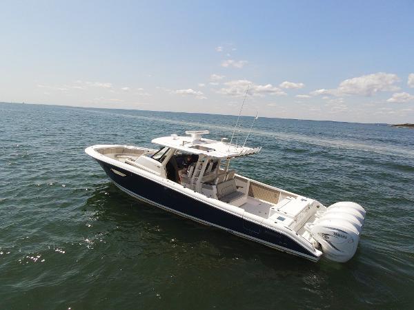 Pursuit S 428 Sport 2021 Pursuit S 428 Sport boat cruising on open water under a clear sky.