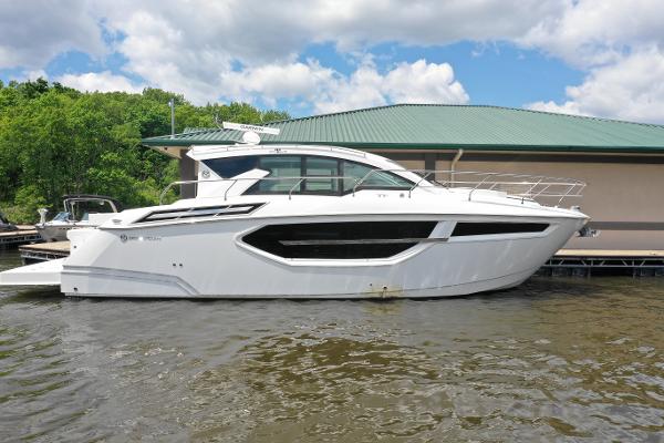 Cruisers Yachts 42 Cantius 2019 Cruisers Yachts 42 Cantius docked, sleek white design, under cloudy sky.