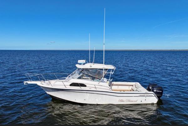 Grady-White Marlin 300 2003 Grady-White Marlin 300 boat on open water under clear blue sky.