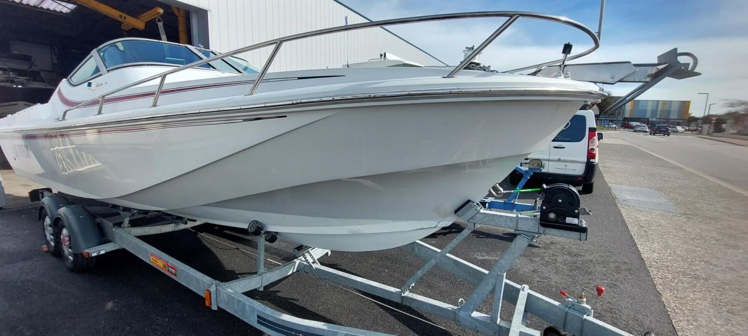 Boston Whaler Temptation 2500 1988 Boston Whaler Temptation 2500 boat on trailer, parked outdoors.
