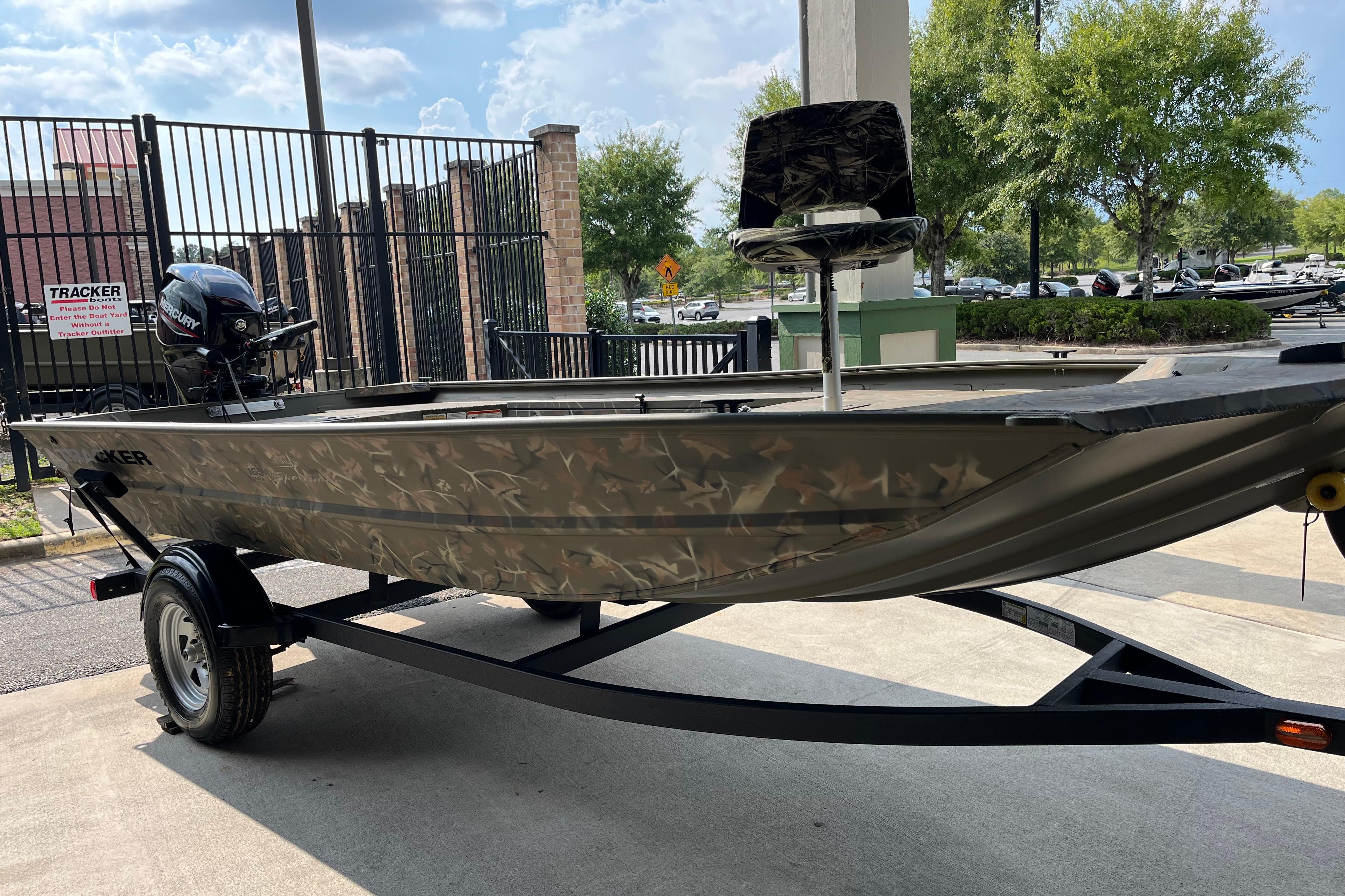 Tracker Grizzly 1654 T Sportsman 2025 Tracker Grizzly 1654 T Sportsman boat with camouflage design on a trailer.