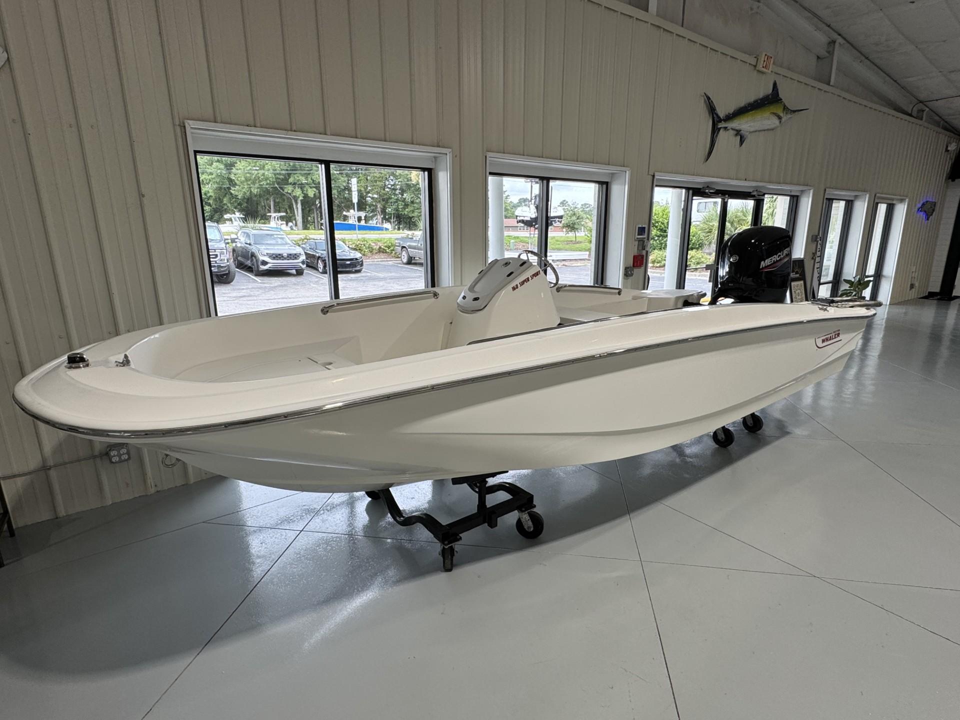 Boston Whaler 160 Super Sport 2023 Boston Whaler 160 Super Sport boat displayed indoors on a stand.