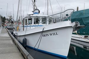 Custom Sprague Custom 2006 Sprague boat "Iron Will" docked at a marina on a cloudy day.