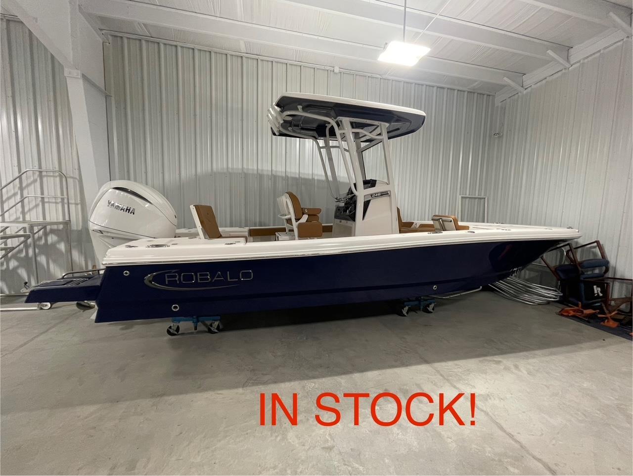Robalo 246 Cayman 2025 Robalo 246 Cayman boat in stock, displayed in a showroom.