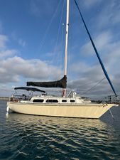 Islander Mk Ii 1976 Islander Mk II sailboat on calm water under a partly cloudy sky.