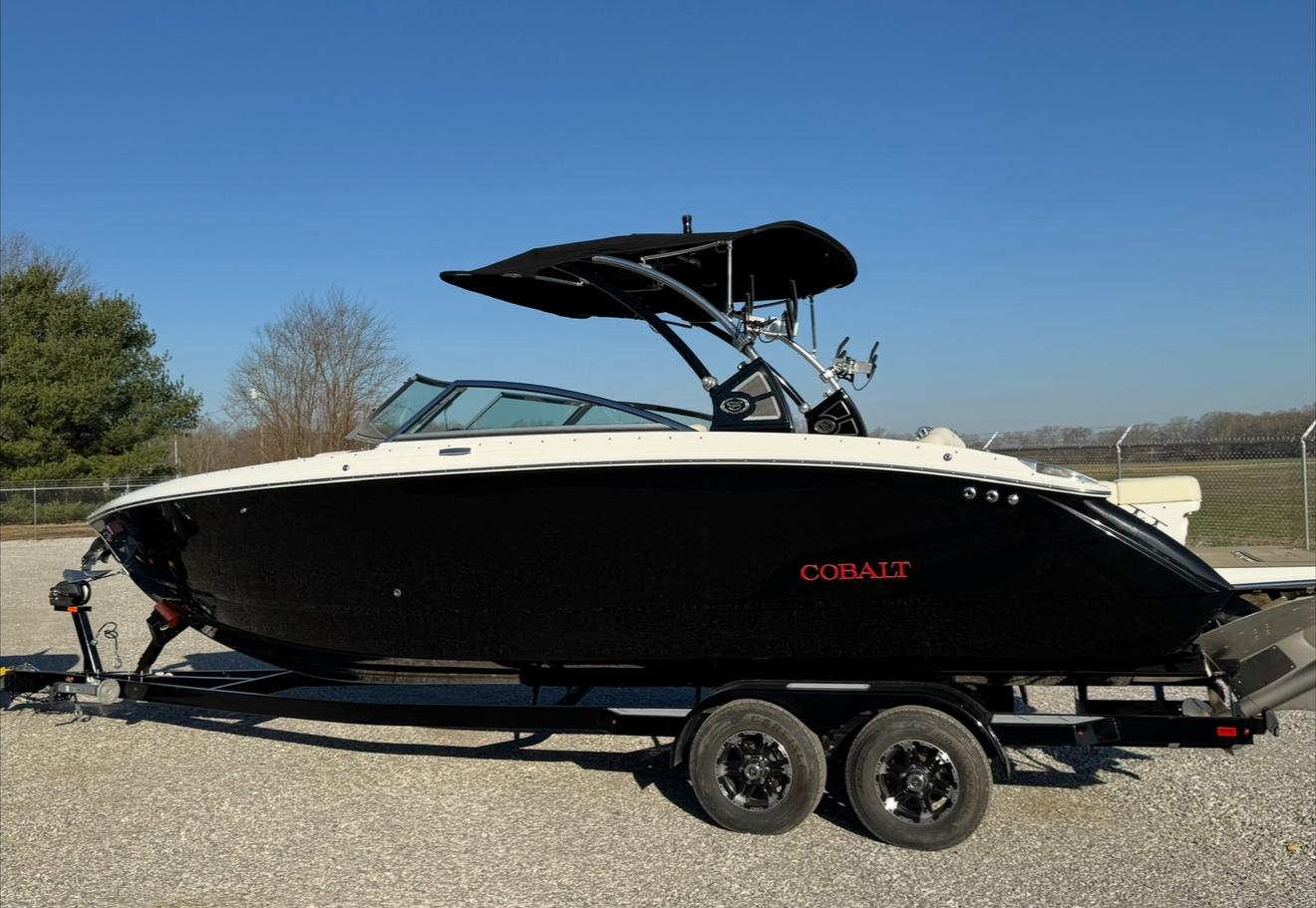 Cobalt R7 Surf 2020 Cobalt R7 Surf boat on trailer, black and white design, parked outdoors.