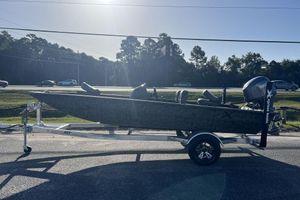 Xpress XP170 2026 Xpress XP170 boat on trailer, parked roadside under clear sky.