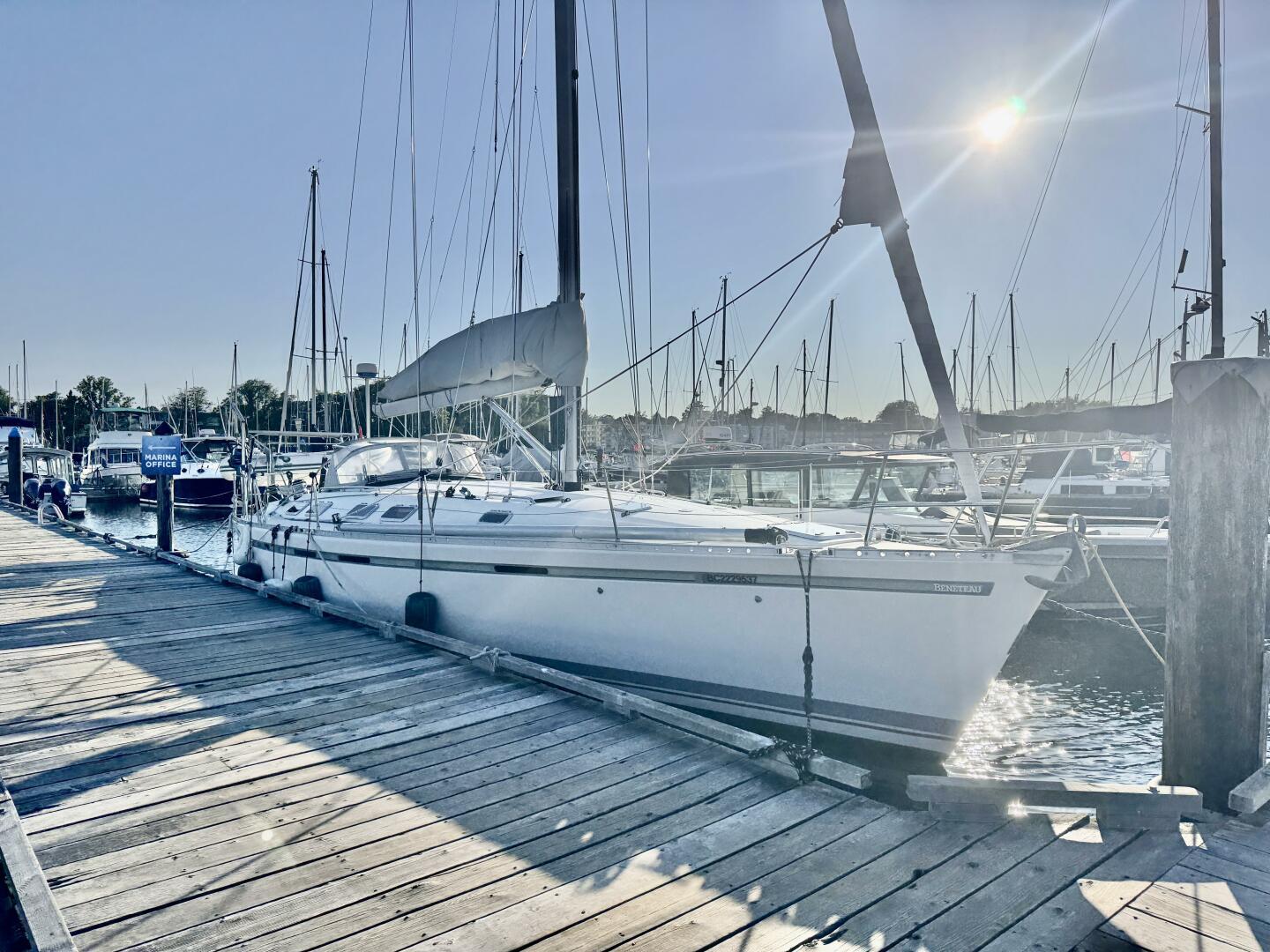 Beneteau 45 First Sailboat Beneteau 45 First 1991 docked at marina under bright sun.