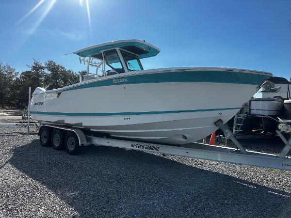 Blackfin 302CC 2023 Blackfin 302CC boat on trailer under clear blue sky.