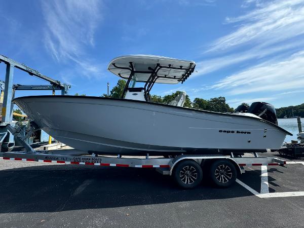 Cape Horn 27 XS 2025 Cape Horn 27 XS boat on trailer, parked outdoors under clear blue sky.