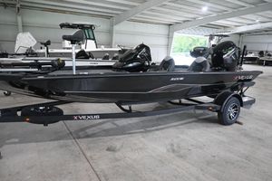 Vexus Defender 181 2026 Vexus AVX181 DEFENDER boat in showroom, sleek black design, on trailer.
