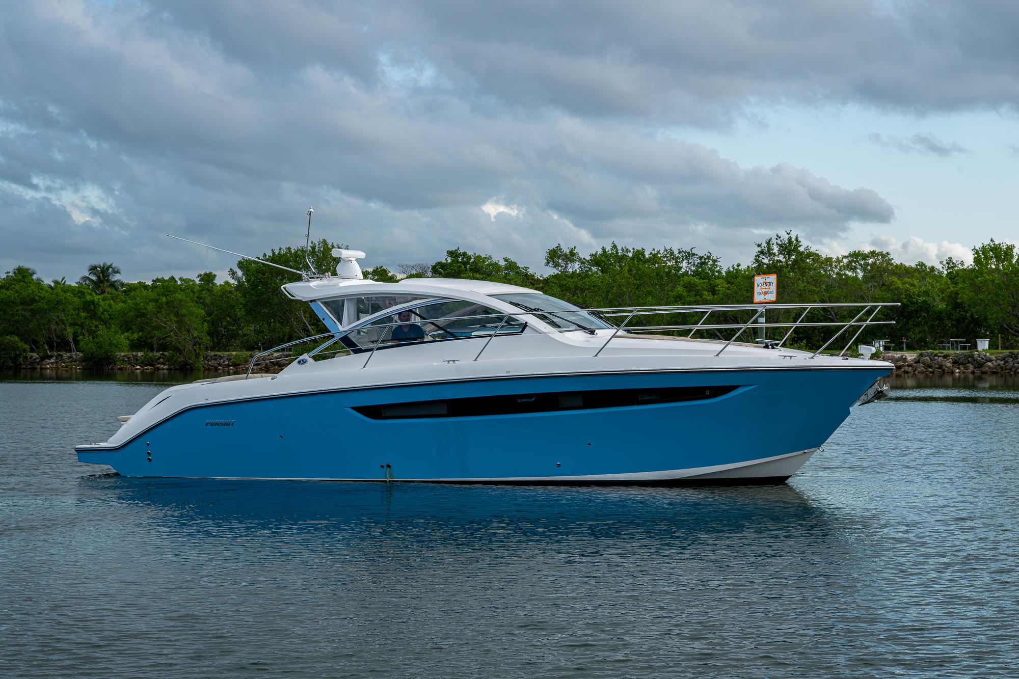 Pursuit SC 365i Sport Coupe 2018 Pursuit SC 365i Sport Coupe yacht on calm water, under cloudy sky.