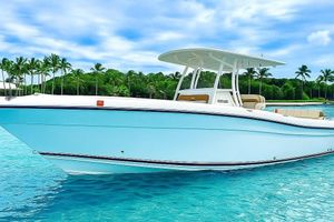 Century 3200 Center Console 2019 Century 3200 Center Console boat on clear blue water with palm trees.