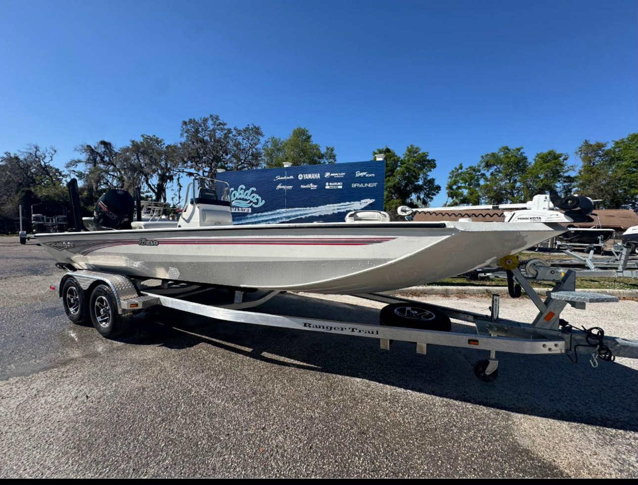 Ranger RB210 2025 Ranger RB210 boat on trailer, parked outdoors under clear blue sky.