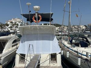 Azimut 46 2005 Azimut 46 yacht docked at marina, surrounded by other boats, clear sky above.