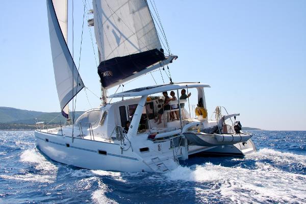Leopard 40 2007 Leopard 40 catamaran sailing on open sea with passengers enjoying the ride.